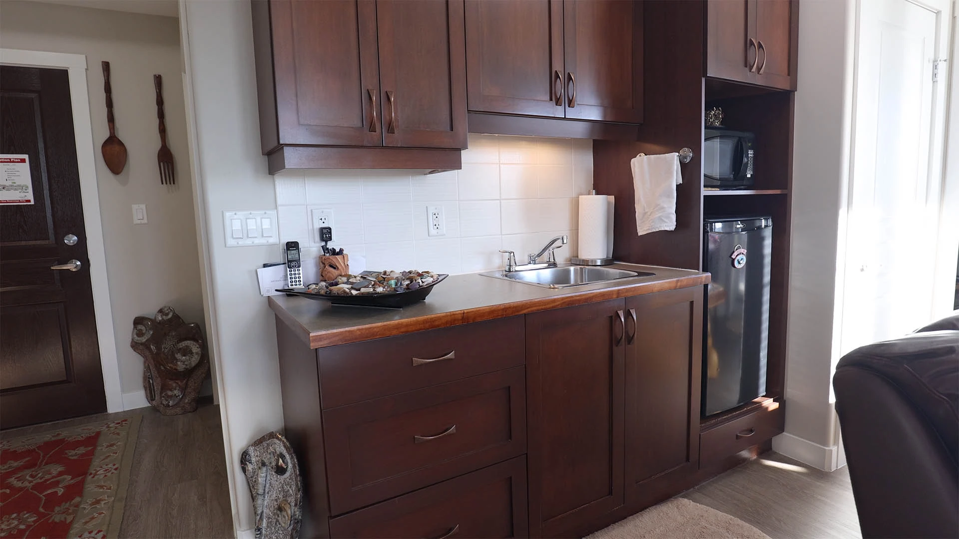 Small kitchen with brown cupboards and counter tops