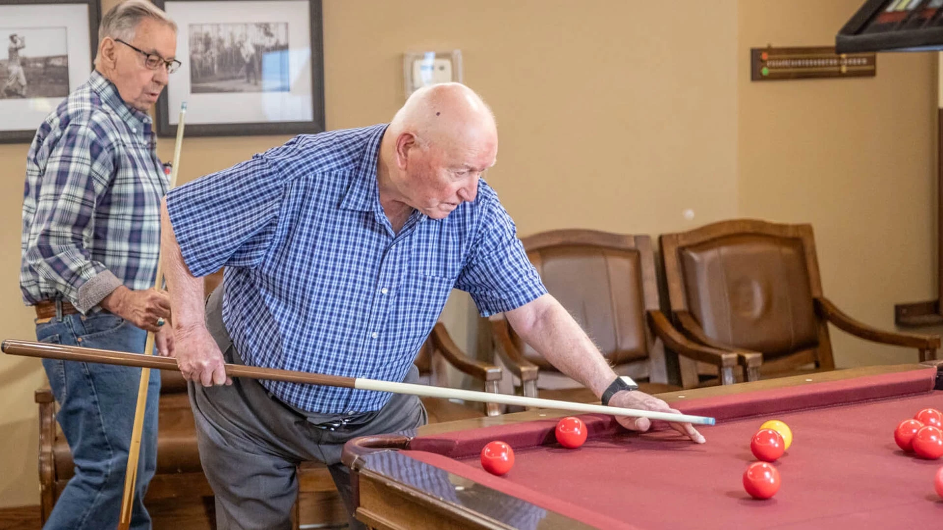Elderly men playing billiards